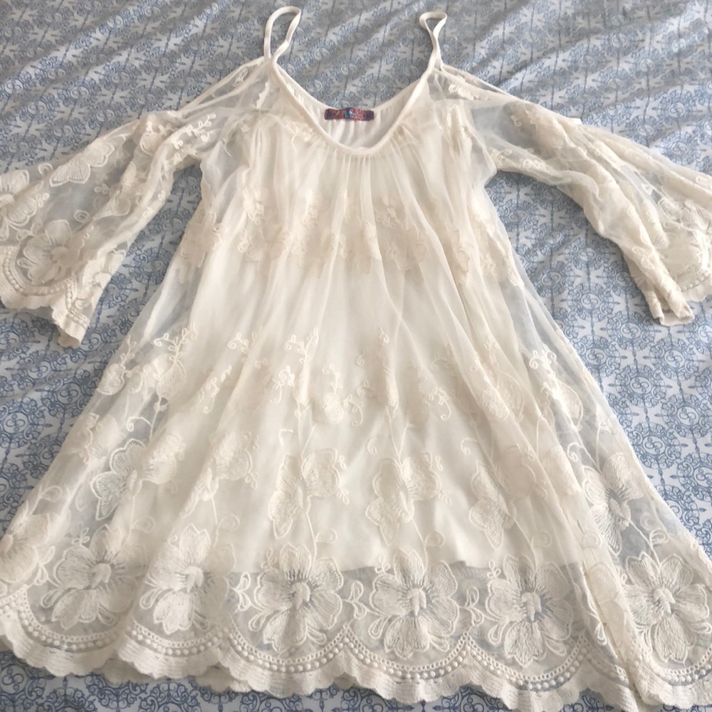 White lace dress, stops 2-3 inches above the knee